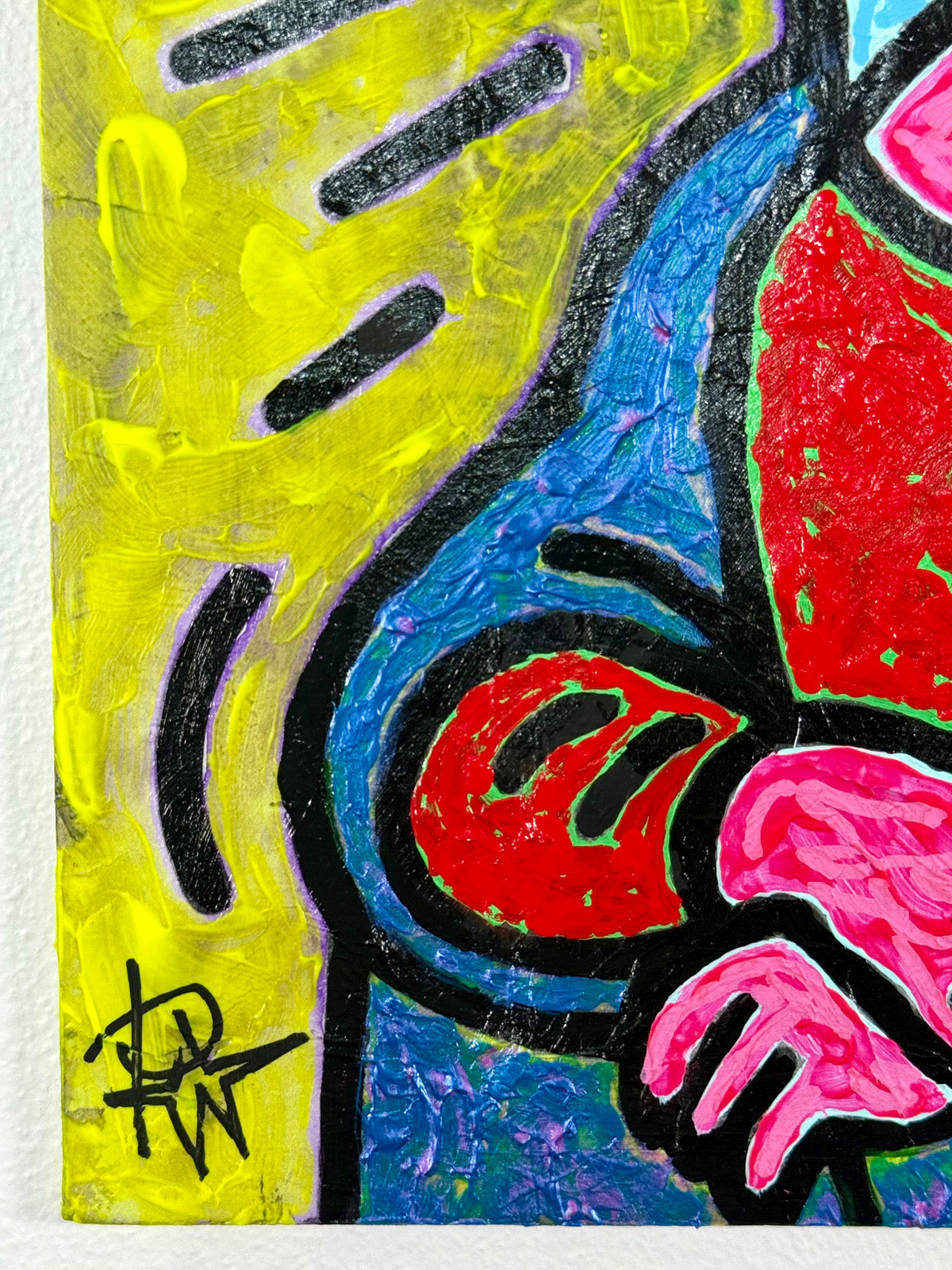 Detail view of Mona by Audrey Néron showing the artist’s signature in black on a vibrant yellow background, with textured acrylic layers and bold Pop Icon outlines.