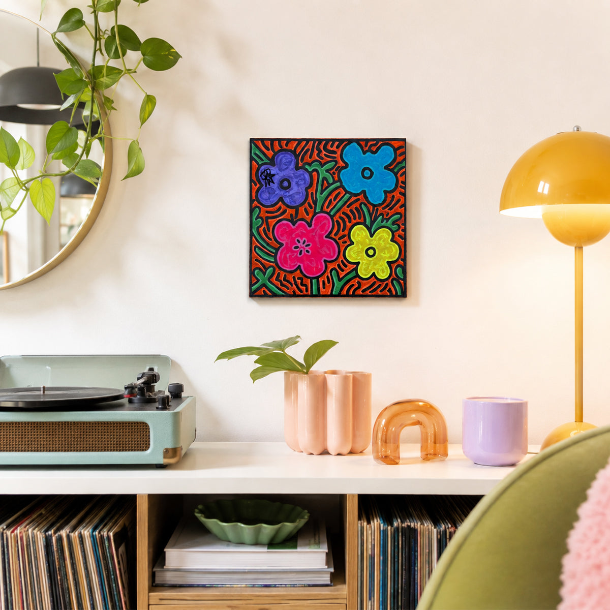 FLO by Audrey Néron displayed in a retro-inspired interior with a record player, plants and a yellow lamp, showing the scale of the 10 × 10 inch Pop Relic painting.